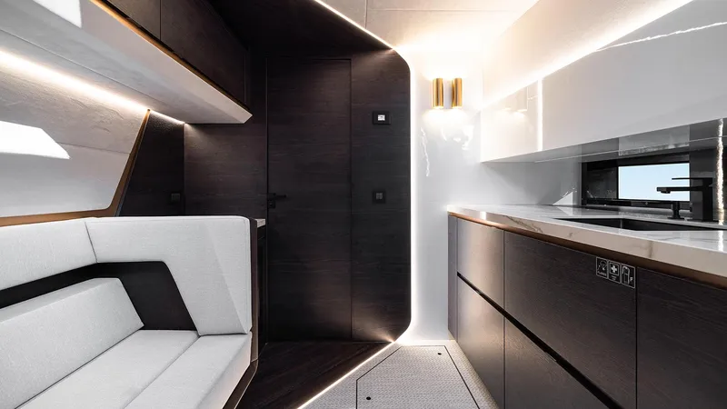 Chapter 3 Yacht Photos Pics 2024 Vanquish Yachts VQ70 interior with modern design, featuring sleek cabinetry and comfortable seating.