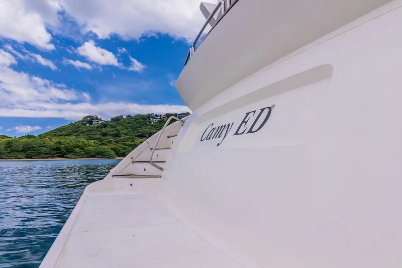 Camy Ed Yacht Photos Pics Luxury yacht Azimut 105 Grande, 2006 model, docked near lush green shoreline.