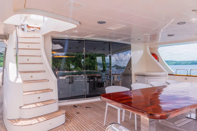 Camy Ed Yacht Photos Pics Luxurious 2006 Azimut 105 Grande yacht deck with elegant dining area and scenic ocean view.