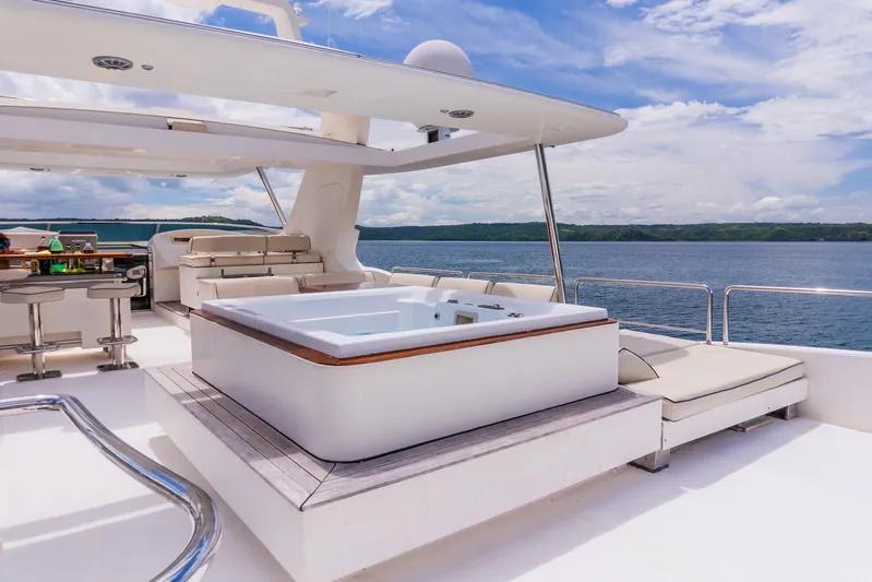 Camy Ed Yacht Photos Pics Luxurious 2006 Azimut 105 Grande yacht deck with jacuzzi and seating area.