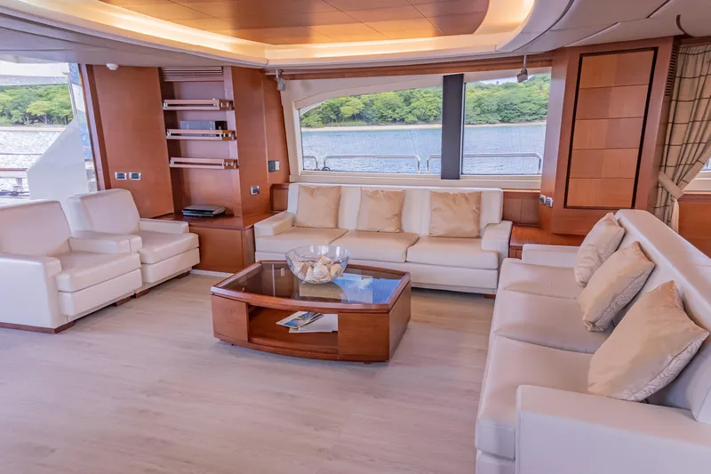 Camy Ed Yacht Photos Pics Luxurious interior of 2006 Azimut 105 Grande yacht with elegant seating and scenic window view.