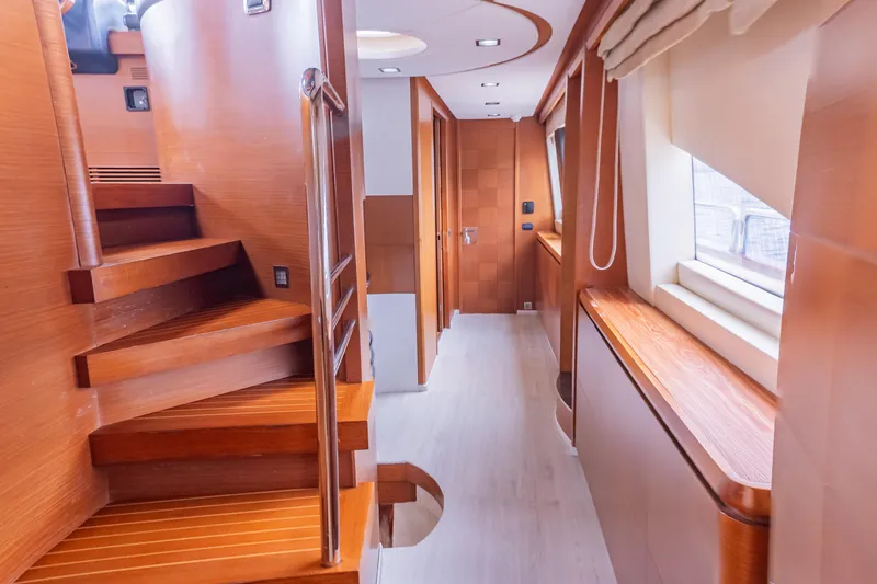 Camy Ed Yacht Photos Pics Luxurious interior of 2006 Azimut 105 Grande yacht with wooden staircase and hallway.