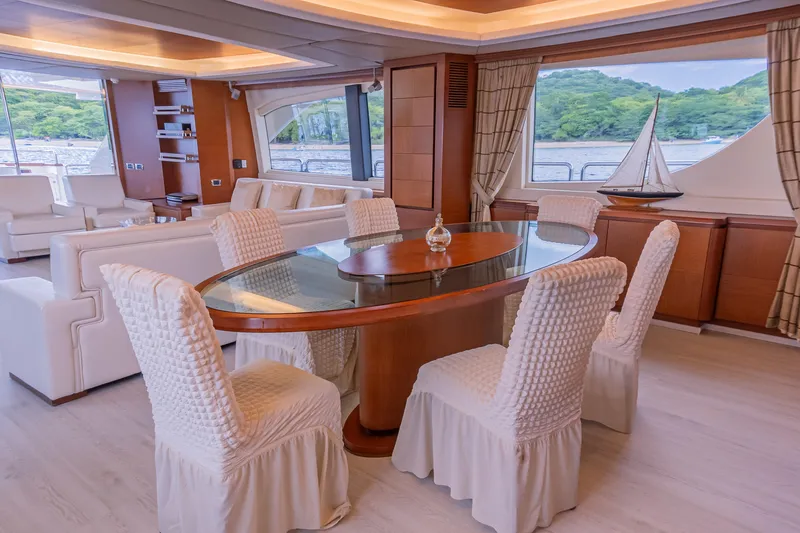 Camy Ed Yacht Photos Pics Luxurious interior of 2006 Azimut 105 Grande yacht with elegant dining area and scenic views.