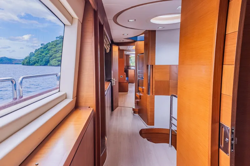 Camy Ed Yacht Photos Pics Luxurious interior of 2006 Azimut 105 Grande yacht with wooden finishes and scenic window view.