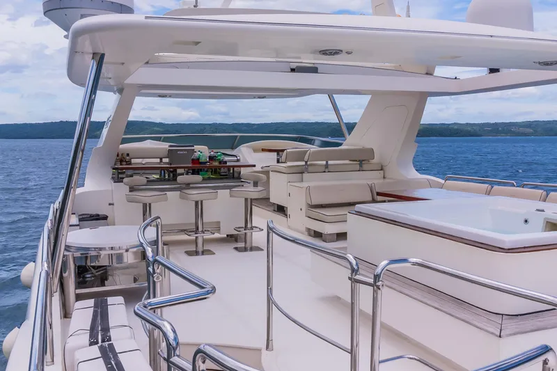 Camy Ed Yacht Photos Pics Luxurious 2006 Azimut 105 Grande yacht deck with bar and seating area.