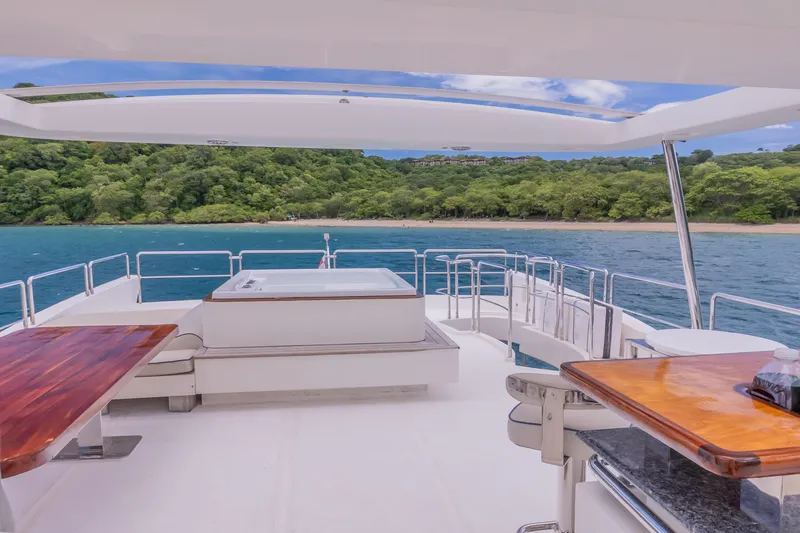 Camy Ed Yacht Photos Pics Luxurious 2006 Azimut 105 Grande yacht deck with ocean and lush green shoreline view.