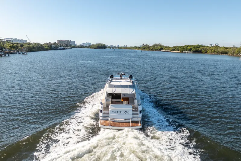 Water Dog Yacht Photos Pics 2024 Riviera 5400 Sport Yacht cruising on a scenic waterway.
