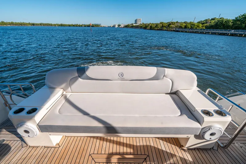 Water Dog Yacht Photos Pics 2024 Riviera 5400 Sport Yacht's rear seating area overlooking serene water.