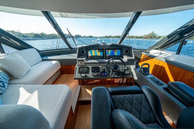 Water Dog Yacht Photos Pics 2024 Riviera 5400 Sport Yacht helm with luxurious seating and advanced navigation system.