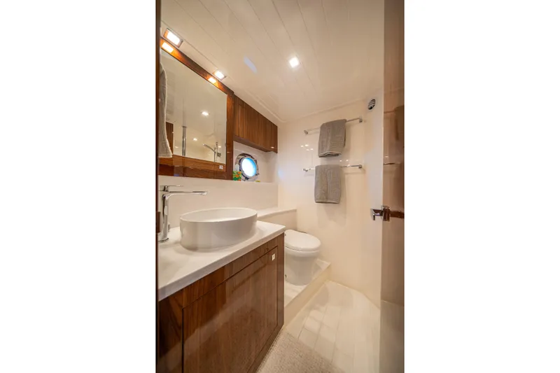 Water Dog Yacht Photos Pics Luxurious bathroom in 2024 Riviera 5400 Sport Yacht with modern fixtures and elegant design.