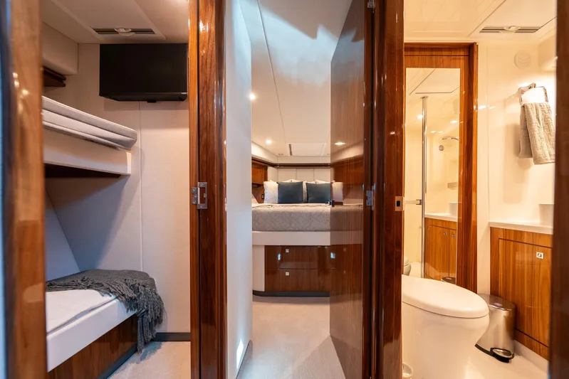 Water Dog Yacht Photos Pics Luxurious interior of 2024 Riviera 5400 Sport Yacht with bedroom and bathroom.