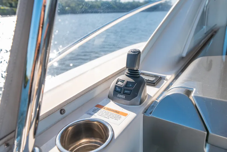 Water Dog Yacht Photos Pics 2024 Riviera 5400 Sport Yacht control panel with joystick and cup holder.