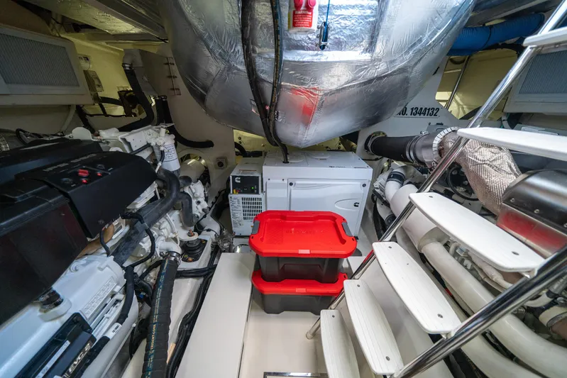 Water Dog Yacht Photos Pics Engine room of 2024 Riviera 5400 Sport Yacht with machinery and storage containers.