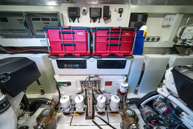Water Dog Yacht Photos Pics Engine room of 2024 Riviera 5400 Sport Yacht with organized toolboxes and equipment.