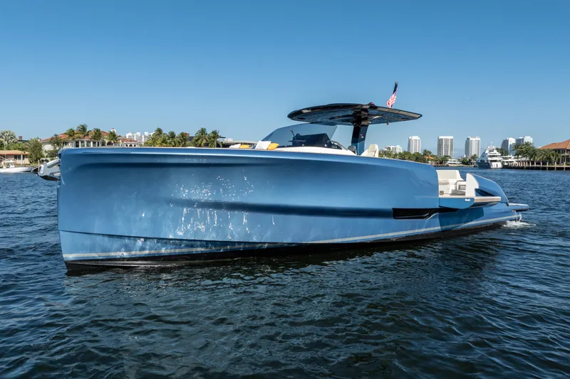  Yacht Photos Pics 2025 Solaris Power 44 Open yacht on water, sleek blue design, cityscape background.