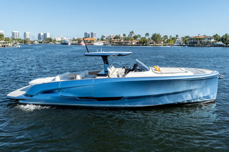  Yacht Photos Pics 2025 Solaris Power 44 Open yacht on calm water, city skyline in background.