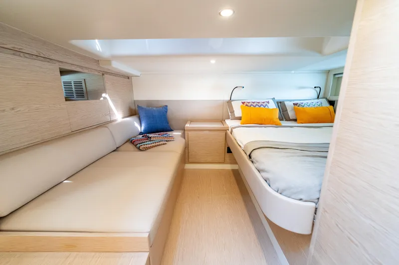  Yacht Photos Pics Luxurious interior of 2025 Solaris Power 44 Open yacht with cozy seating and bedding.
