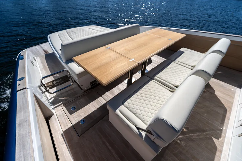  Yacht Photos Pics Luxurious seating area on 2025 Solaris Power 44 Open yacht, featuring elegant wood table.