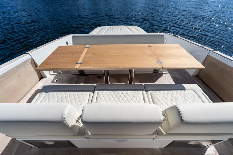  Yacht Photos Pics Luxurious seating and table on 2025 Solaris Power 44 Open yacht deck.