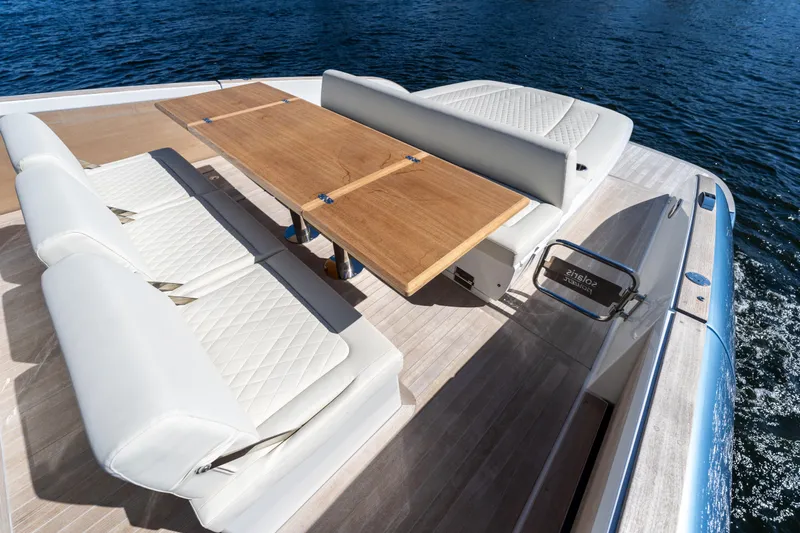  Yacht Photos Pics Luxurious seating area on 2025 Solaris Power 44 Open yacht with wooden table.