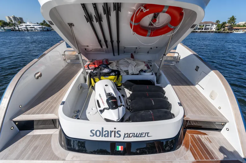  Yacht Photos Pics 2025 Solaris Power 44 Open yacht with open storage compartment, docked by the water.
