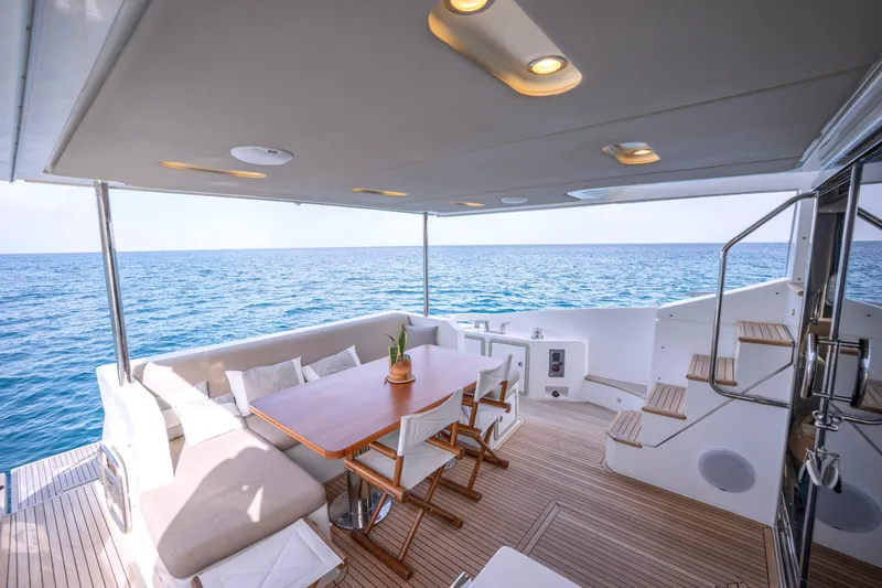 M/y Golden Pearl Yacht Photos Pics Luxurious 2017 Azimut yacht deck with seating, dining table, and ocean view.