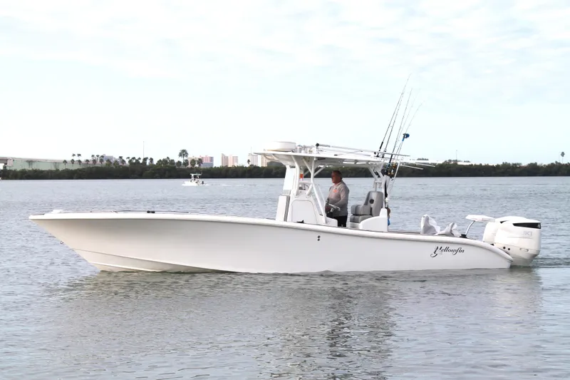  Yacht Photos Pics 2005 Yellowfin 31 Center Console boat on calm water, side view.