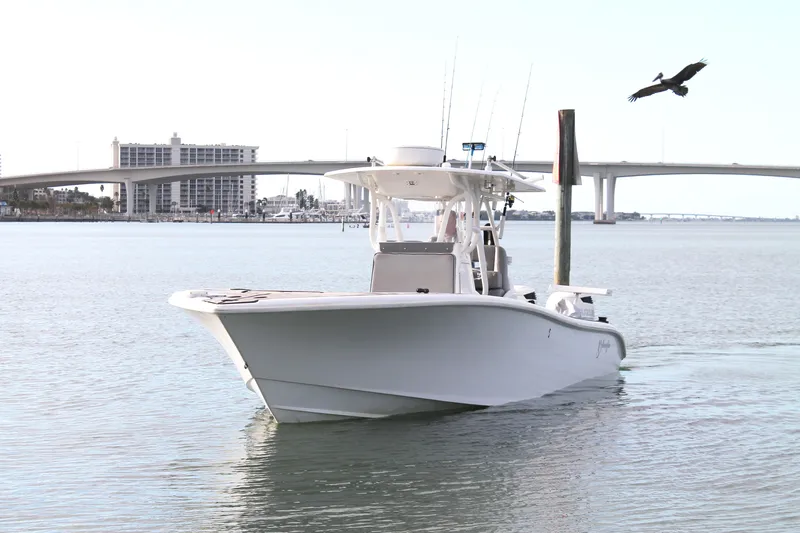  Yacht Photos Pics 2005 Yellowfin 31 Center Console boat on calm water near a bridge.