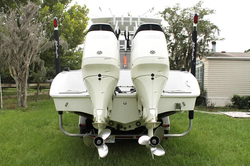  Yacht Photos Pics 2005 Yellowfin 31 Open boat with dual outboard engines, parked on grass.