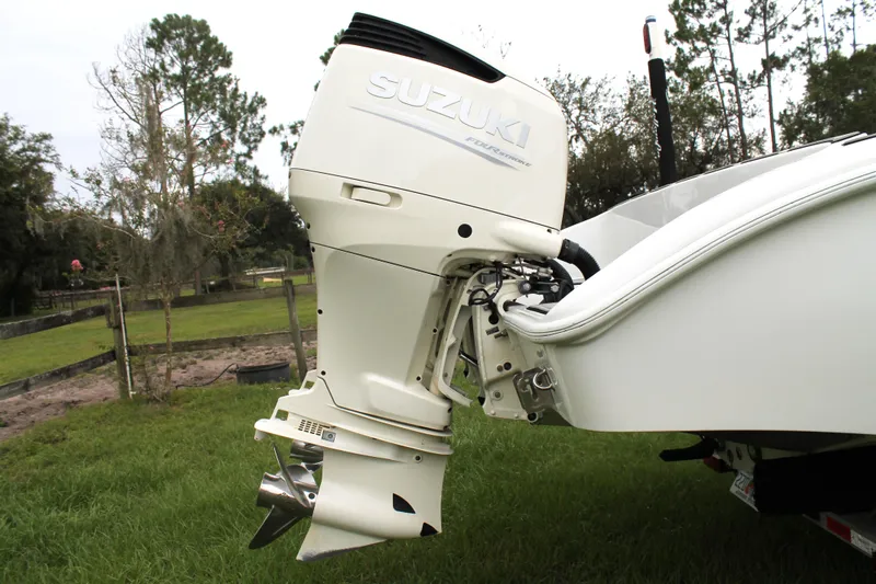  Yacht Photos Pics Suzuki outboard motor on 2005 Yellowfin 31 Open boat, parked on grass.