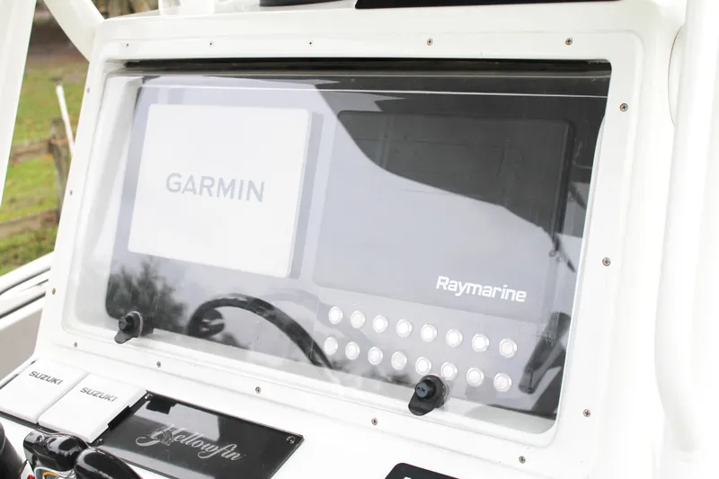  Yacht Photos Pics Control panel of 2005 Yellowfin 31 Open boat with Garmin and Raymarine displays.