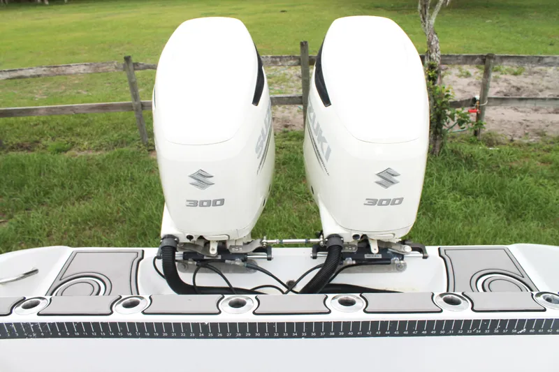  Yacht Photos Pics Twin Suzuki 300 outboard engines on a 2005 Yellowfin 31 Open boat, with a measuring ruler.