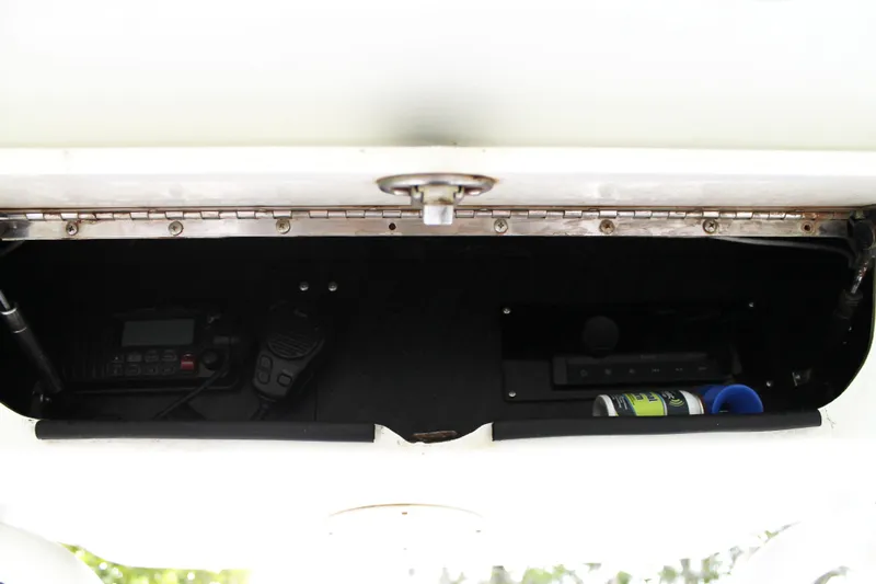  Yacht Photos Pics 2005 Yellowfin 31 Open storage compartment with radio equipment and accessories.