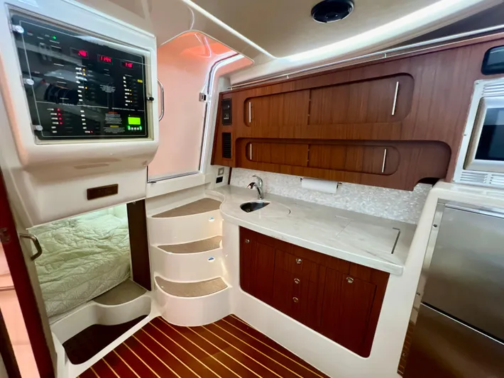 Yacht Photos Pics 2016 Grady-White Express 370 cabin interior with wood accents and modern amenities.