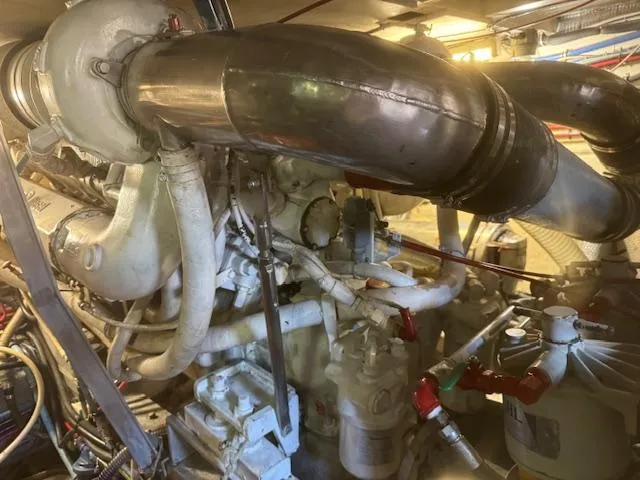  Yacht Photos Pics Engine room of a 1989 Hatteras 52 yacht, showcasing complex machinery and piping.