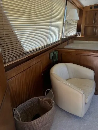  Yacht Photos Pics 1989 Hatteras 52 yacht interior with beige chair and wooden blinds.