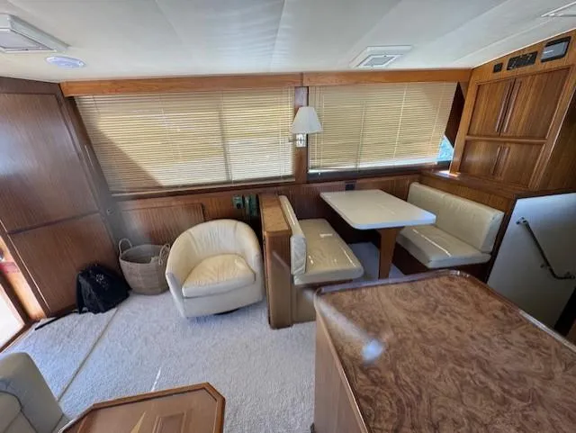  Yacht Photos Pics Interior of 1989 Hatteras 52 yacht with dining area and seating.