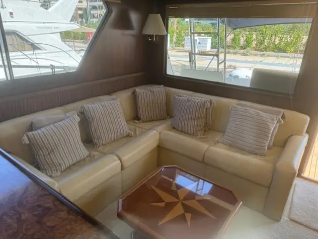  Yacht Photos Pics Interior of 1989 Hatteras 52 yacht with beige sofa and decorative pillows.