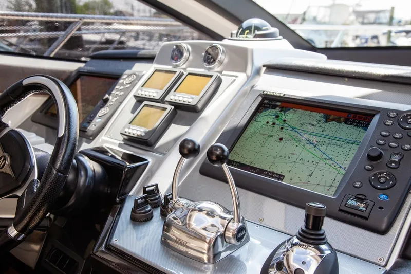  Yacht Photos Pics Dashboard of a 2009 Marquis 500 Sport Coupe yacht with navigation controls and screens.