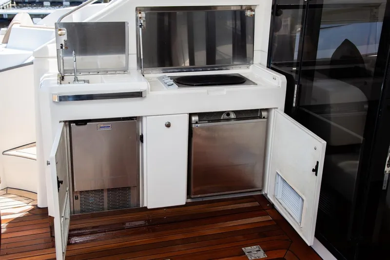  Yacht Photos Pics Outdoor kitchenette on 2009 Marquis 500 Sport Coupe yacht with sink, grill, and storage.