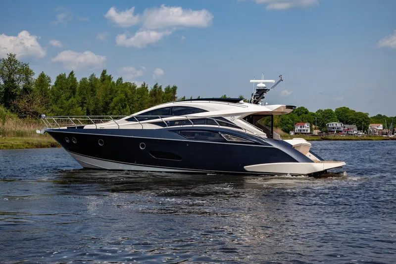  Yacht Photos Pics 2009 Marquis 500 Sport Coupe yacht cruising on a scenic waterway.