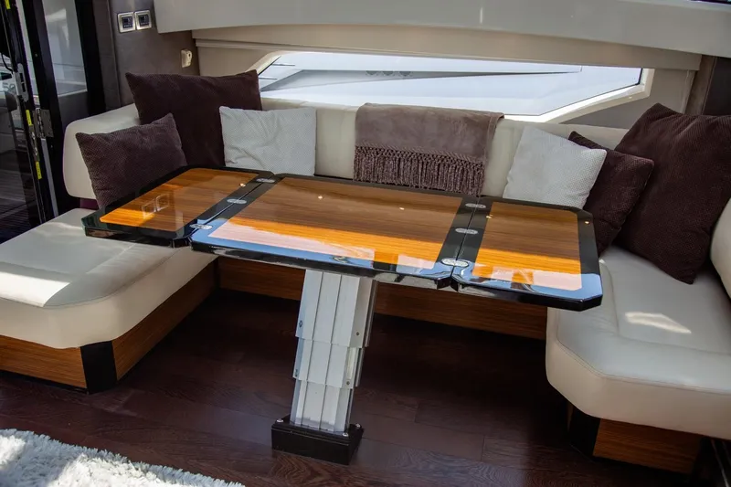  Yacht Photos Pics Luxurious interior of 2009 Marquis 500 Sport Coupe with elegant seating and wooden table.