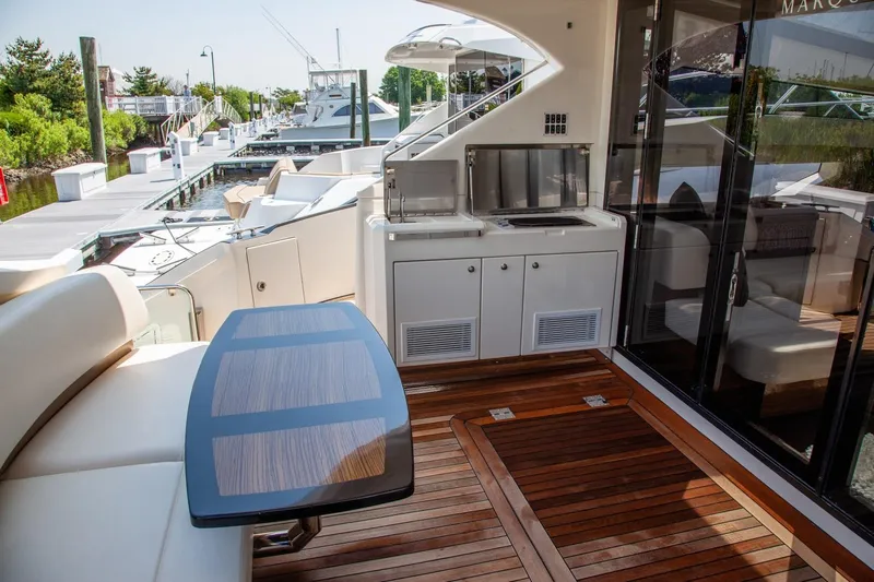  Yacht Photos Pics Luxurious 2009 Marquis 500 Sport Coupe yacht deck with seating and kitchenette.