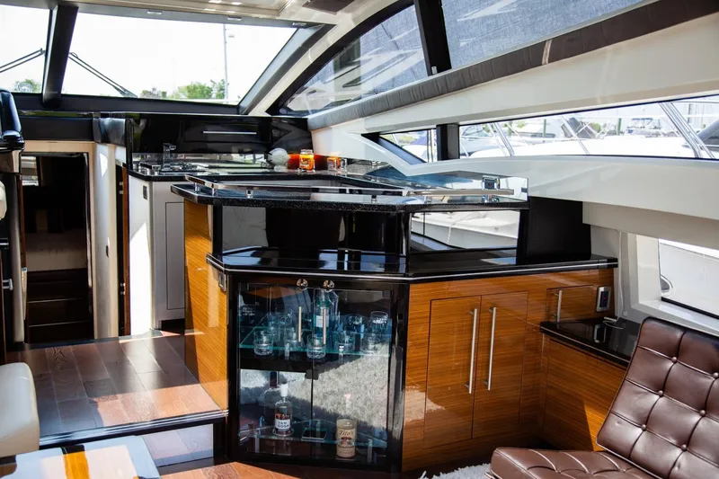  Yacht Photos Pics Luxurious interior of 2009 Marquis 500 Sport Coupe yacht with modern bar and seating area.