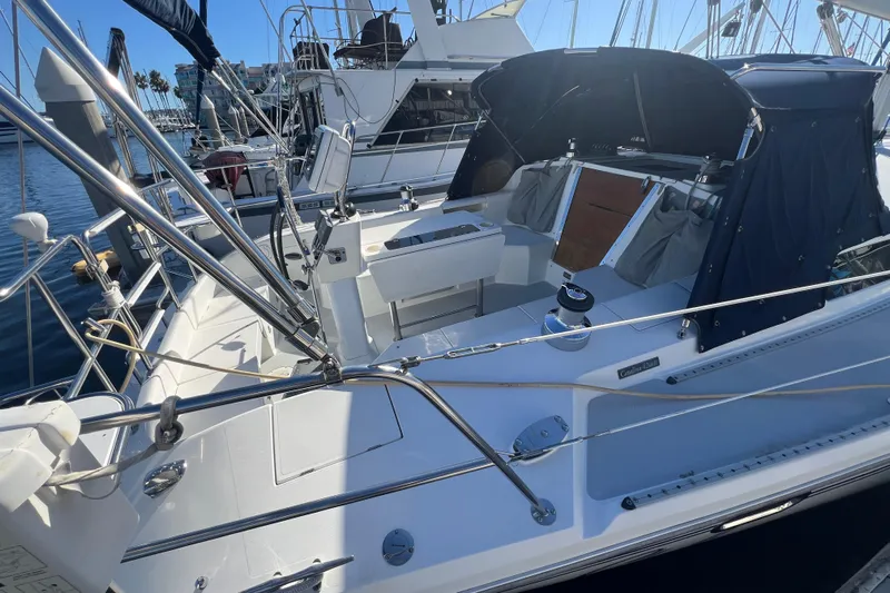  Yacht Photos Pics 2007 Catalina 42 MkII sailboat cockpit with blue canopy, docked in marina.