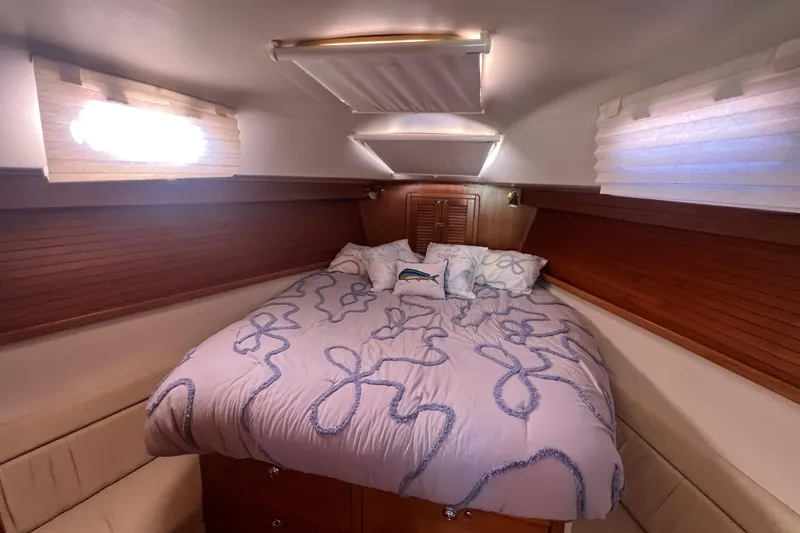  Yacht Photos Pics Cozy cabin interior of 2007 Catalina 42 MkII sailboat with comfortable bedding.