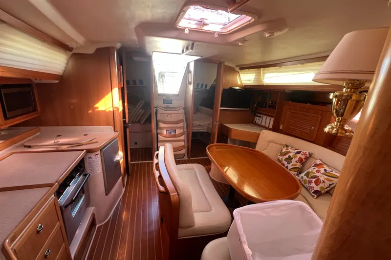  Yacht Photos Pics Interior of 2007 Catalina 42 MkII sailboat with cozy seating and wooden finishes.