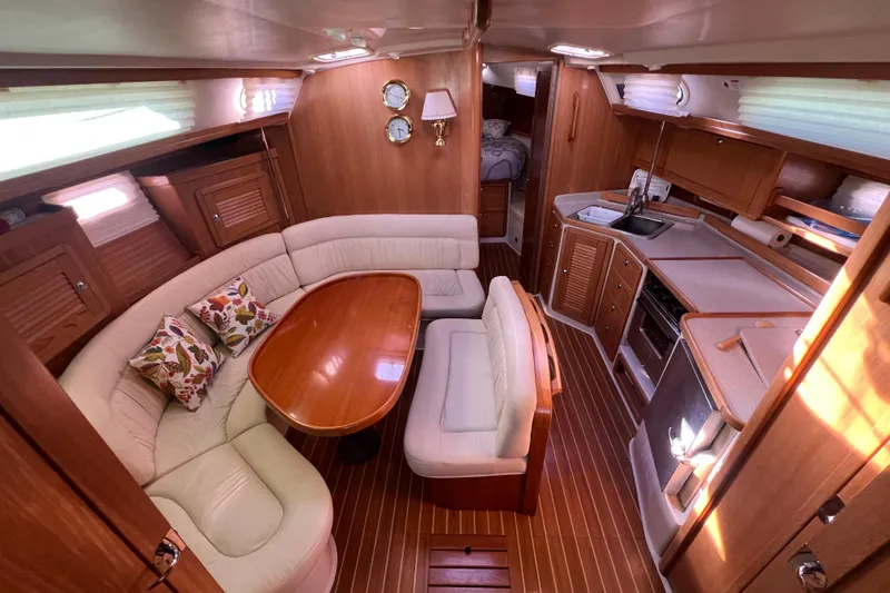  Yacht Photos Pics Luxurious interior of 2007 Catalina 42 MkII sailboat with wood finish and cozy seating.