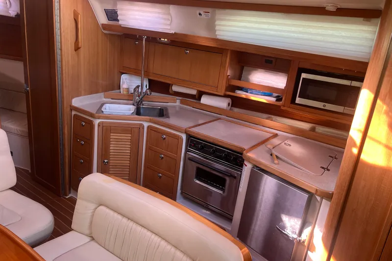  Yacht Photos Pics Luxurious 2007 Catalina 42 MkII yacht interior with modern kitchen and wooden cabinetry.