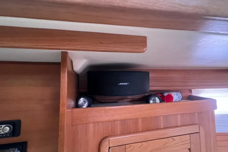  Yacht Photos Pics Bose speaker and flashlights on wooden shelf in 2007 Catalina 42 MkII interior.